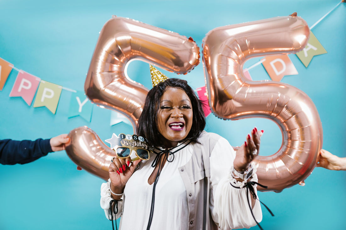 55th birthday party celebration with balloons, banners, and themed tableware and decorations