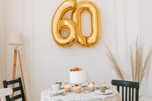 60th birthday party celebration with balloons, banners, and themed tableware and decorations