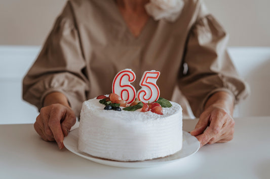 65th birthday party celebration with balloons, banners, and themed tableware and decorations