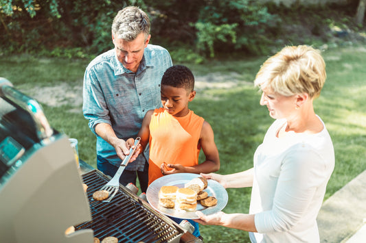 Backyard BBQ party with grill, picnic table, and outdoor barbecue party supplies