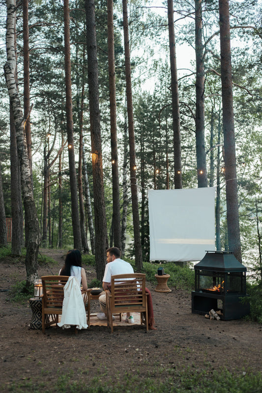 Backyard movie night with projector, blanket seating, and outdoor cinema party supplies