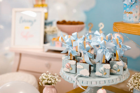 Baby shower celebration with pastel balloons, floral decorations, and baby shower tableware