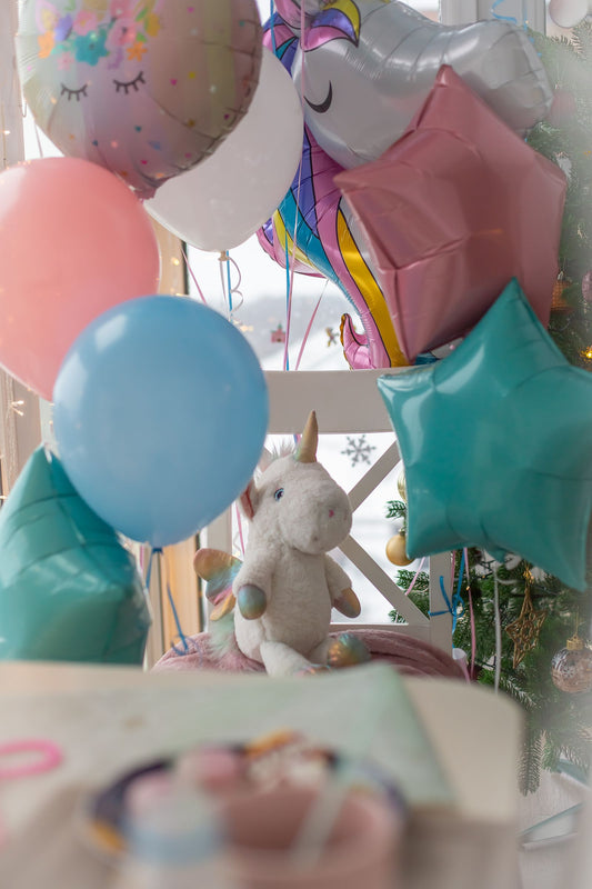 Unicorn themed party with rainbow decorations, pastel tableware, and unicorn party supplies