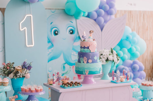 Under the sea themed party with ocean decorations, blue tableware, and sea creature party supplies