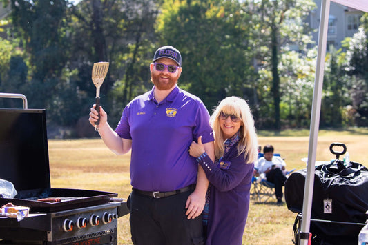 Tailgate party setup with grill, folding chairs, and game day party supplies