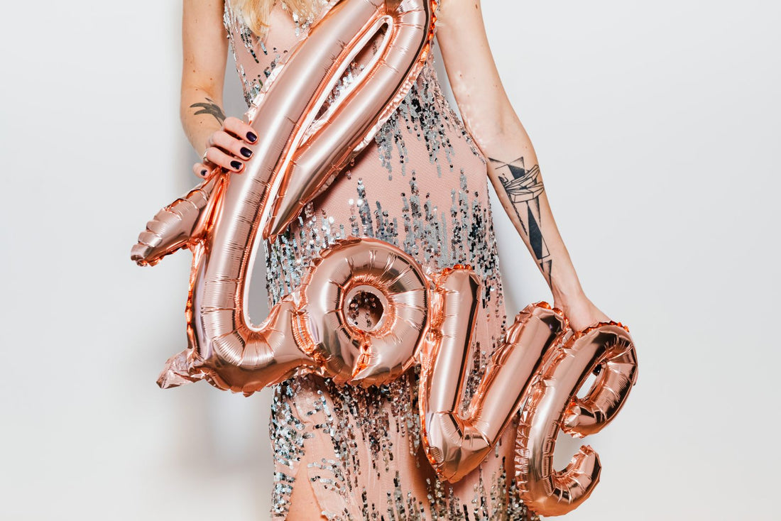 Rose gold party with metallic balloons, shimmering decor, and rose gold party supplies