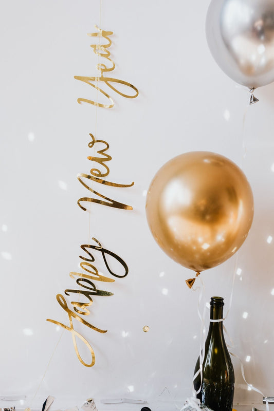 New Year's Eve party with gold balloons, confetti, and countdown party supplies