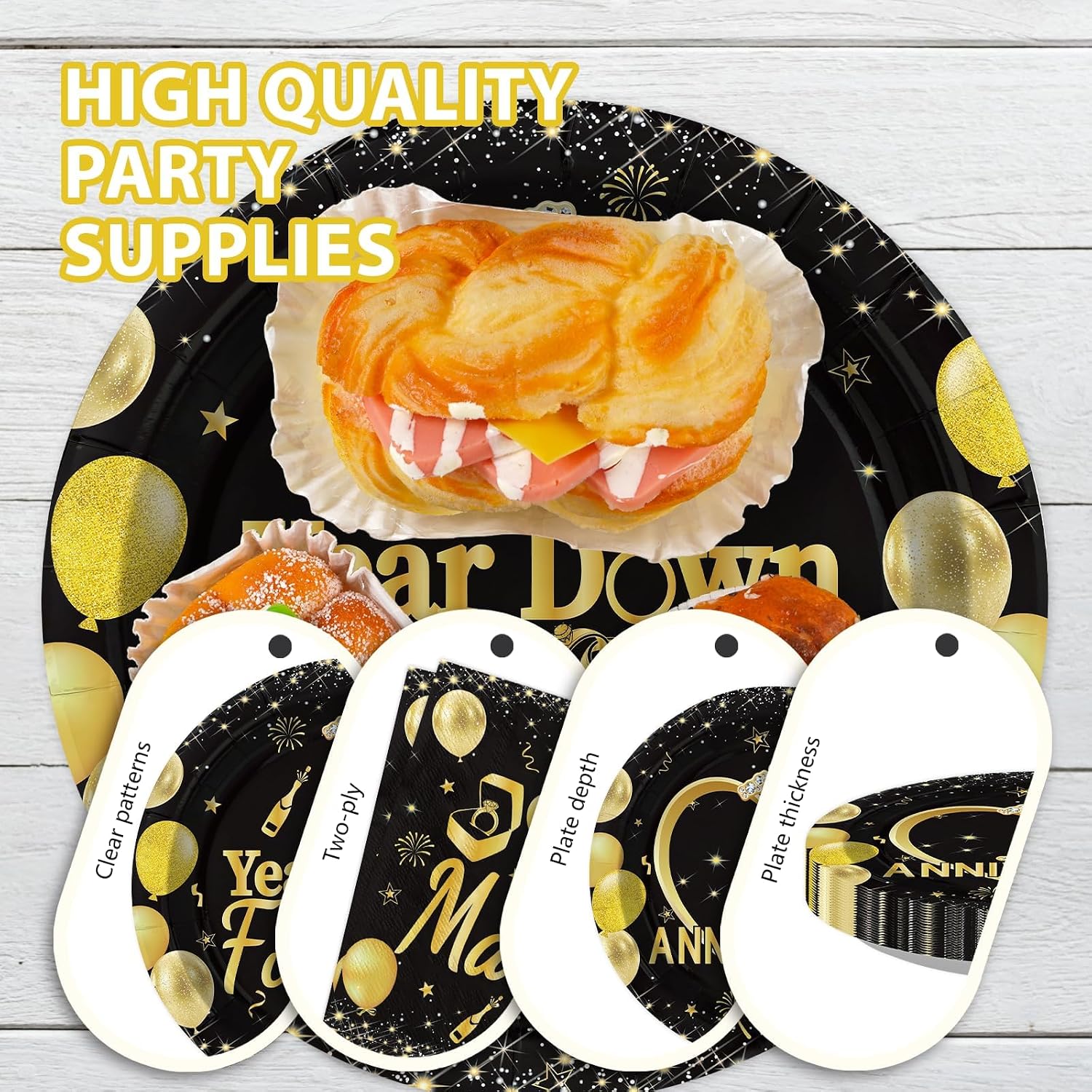 Stack of black gold themed anniversary plates and napkins
