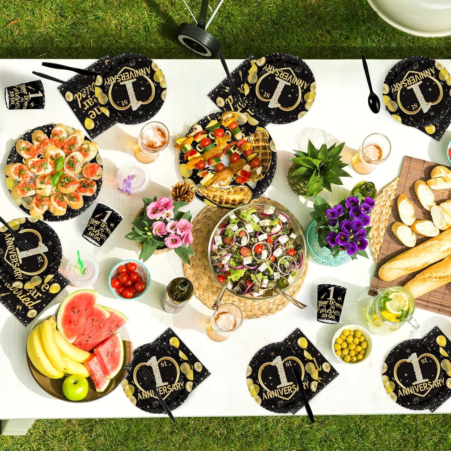 First wedding anniversary party table with black gold tableware