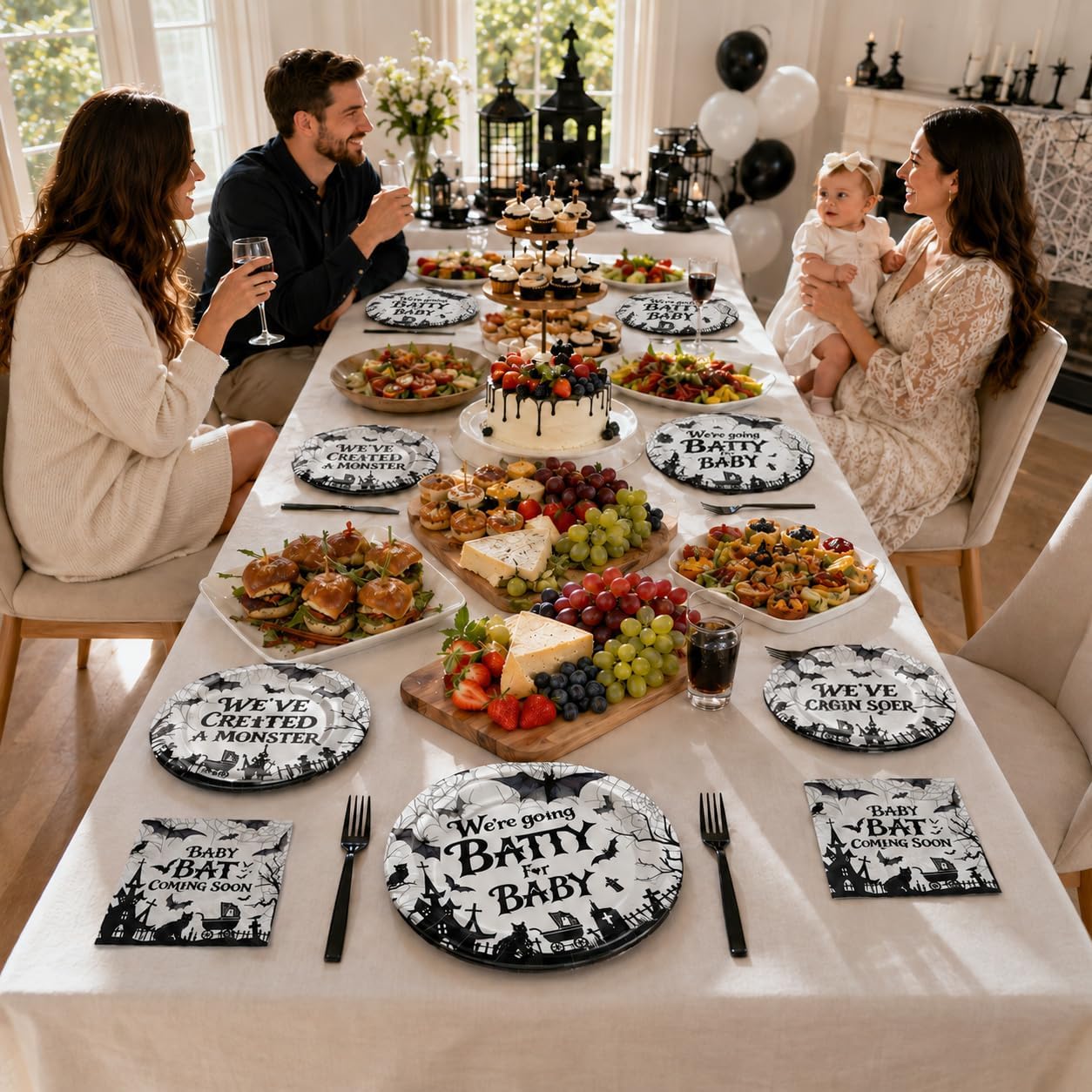 Gothic bat baby shower plates laid out for a spooky celebration