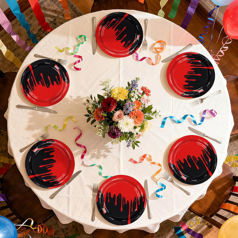 Halloween dessert plates with blood drip edges set out for guests