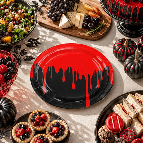 Overhead view of black and red blood drip Halloween plates