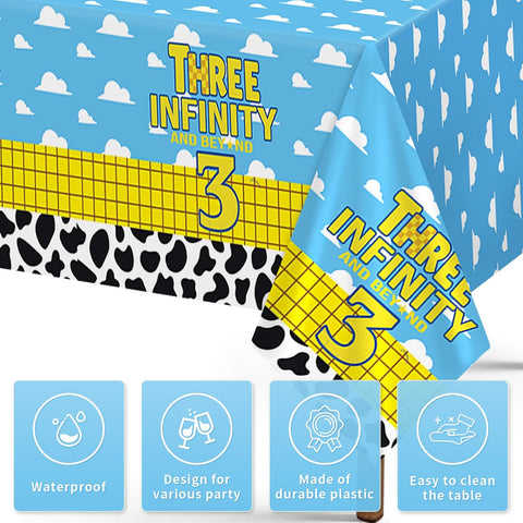 Close-up of cartoon 3rd birthday plastic tablecloth with blue sky clouds cow print and number 3 design