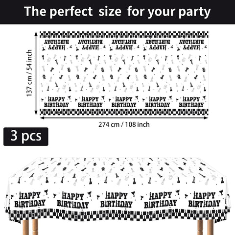 Flat lay of three chess birthday tablecloths showing black and white checkerboard border with international chess pieces