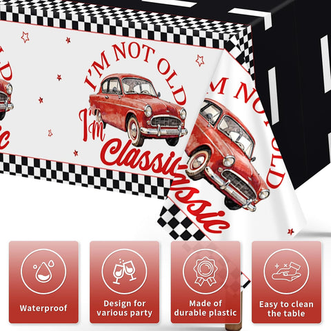 Close-up of classic car birthday tablecloth with red vintage cars and chrome grille details