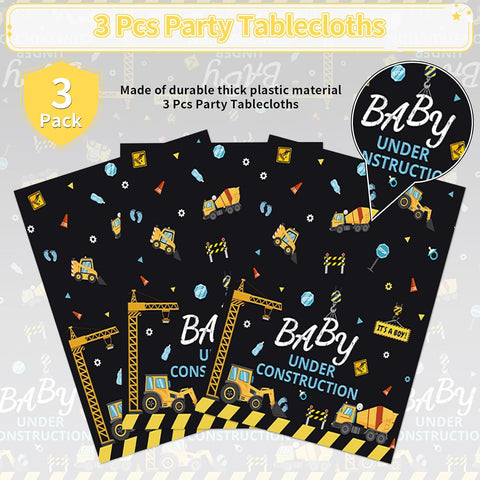 Construction baby shower tablecloth draped on party table with truck themed decorations