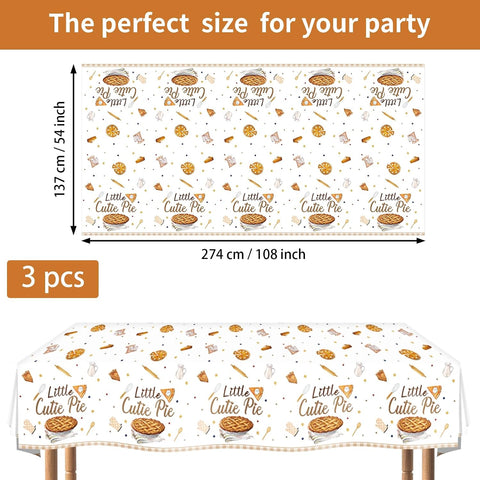 Cutie pie baby shower tablecloth draped on party table with baking themed decorations