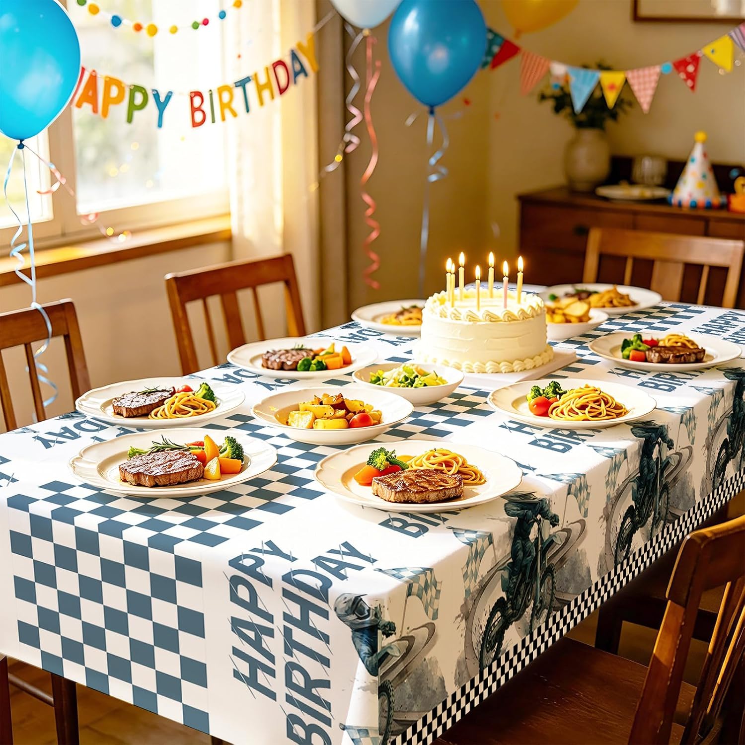 Boys motocross birthday party scene with dirt bike themed tablecloth