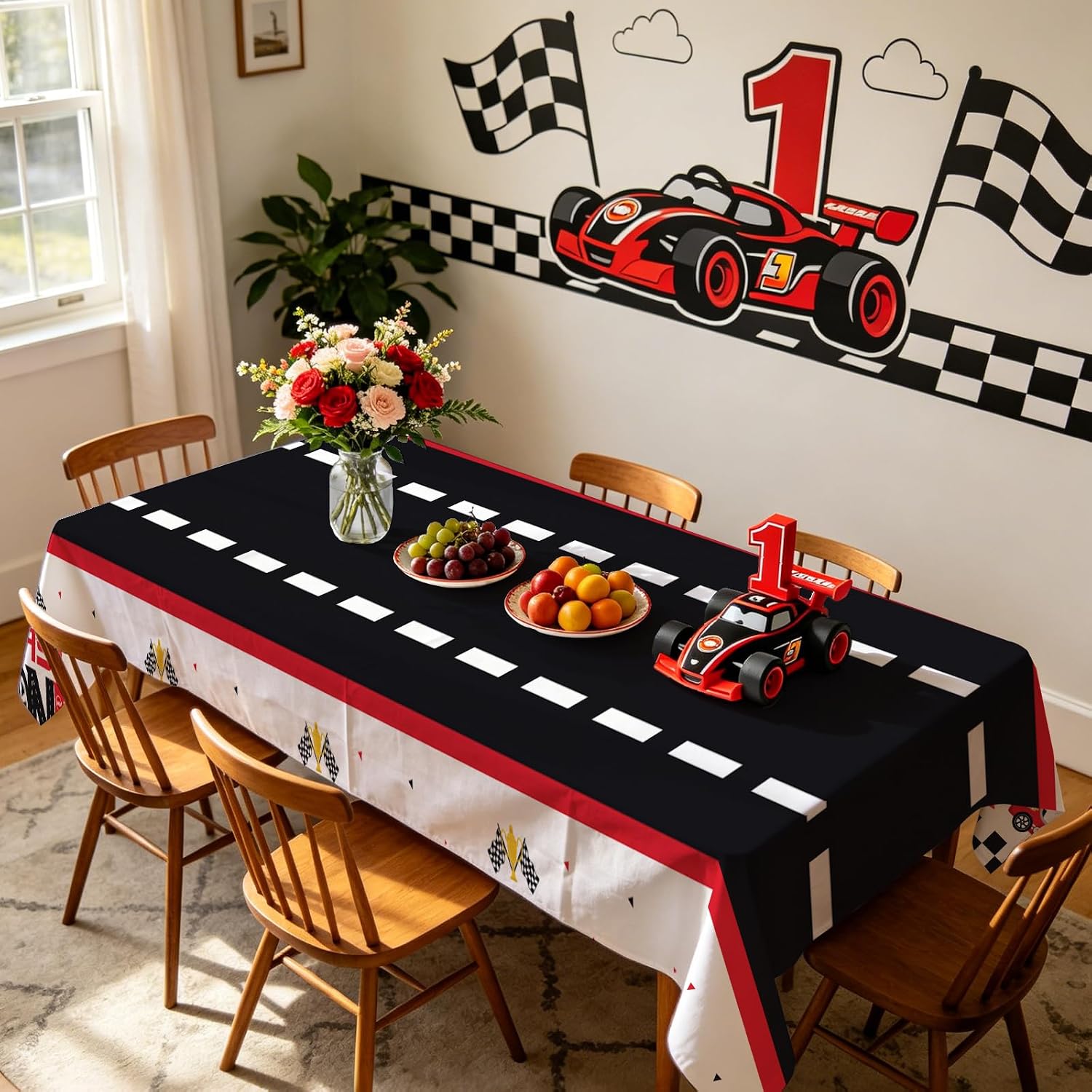 Fast One race car tablecloth draped on party table with racing themed decorations