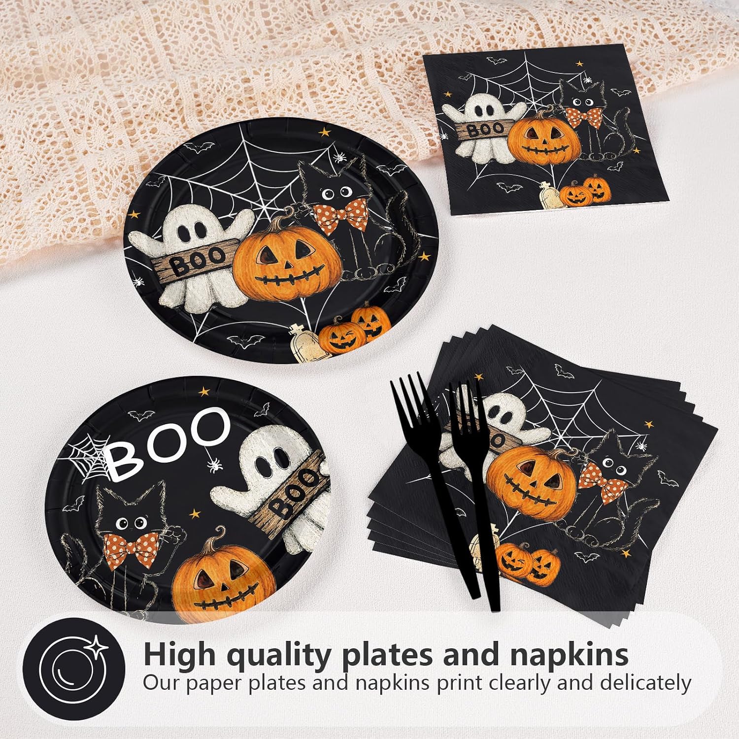 Halloween dessert plates and spooky napkins styled on a black party table