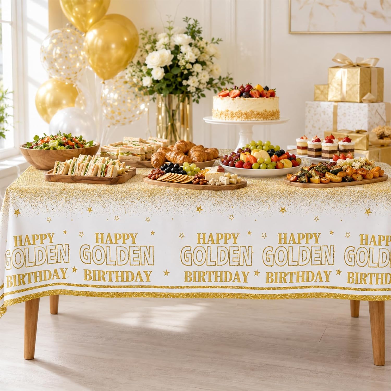 Birthday party scene with white and gold glitter tablecloth