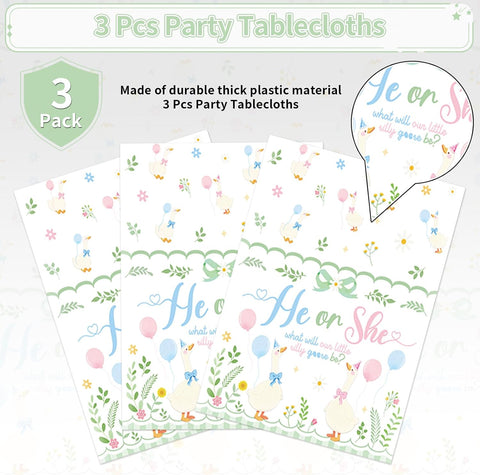 Gender reveal tablecloth draped on party table with baby shower decorations