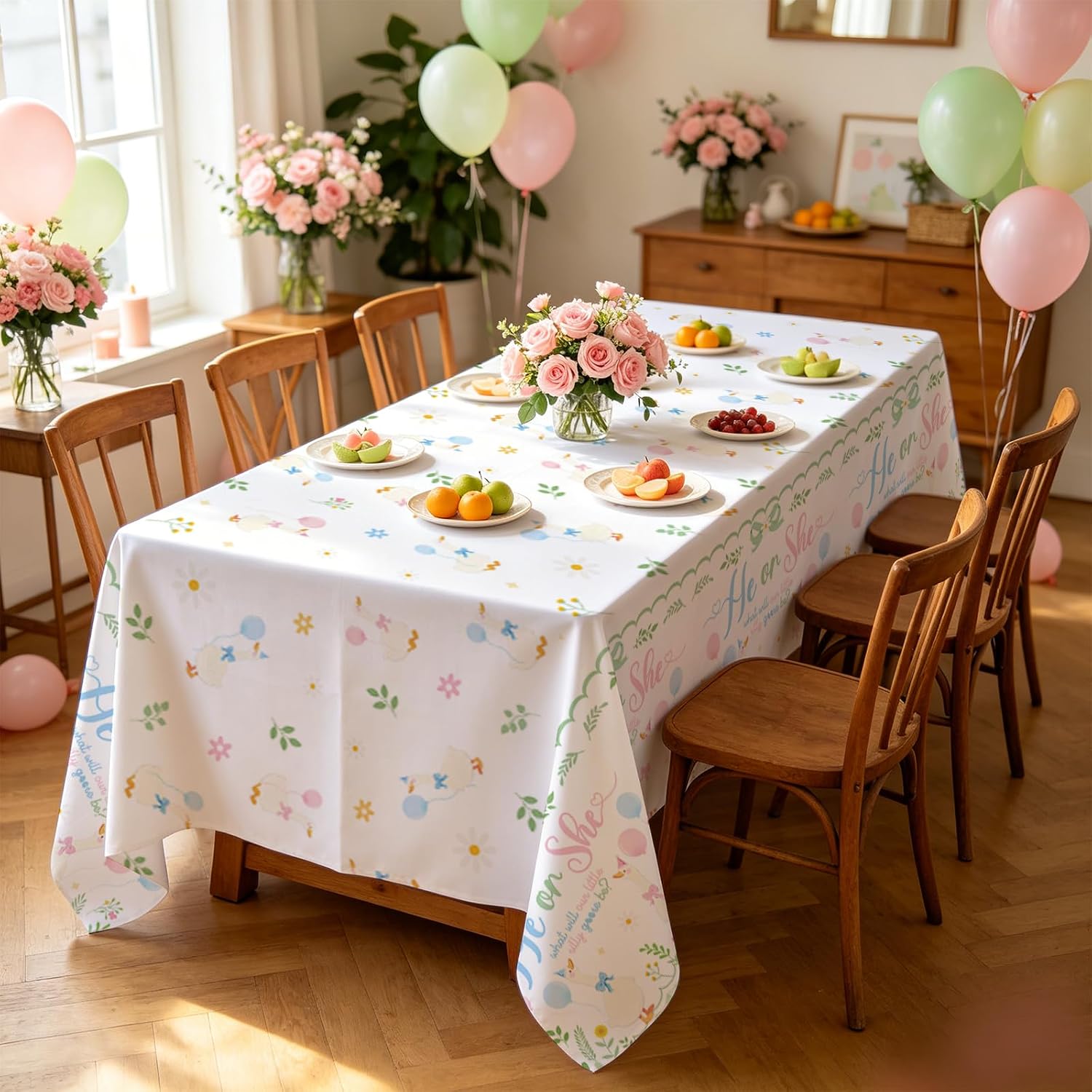 Baby shower gender reveal party scene with silly goose themed tablecloth