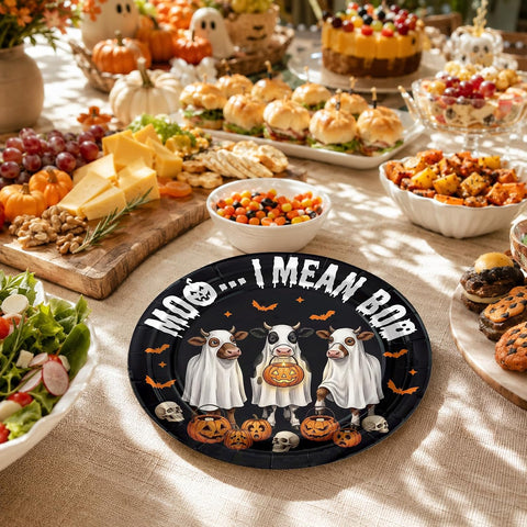 Halloween cow plate on a table with pumpkins and food