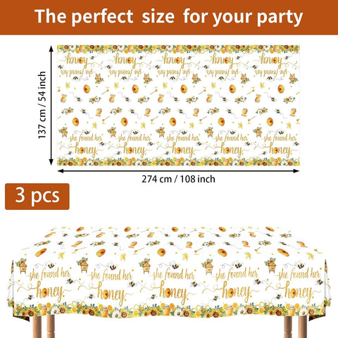 Flat lay of three honey bee tablecloths with bridal design