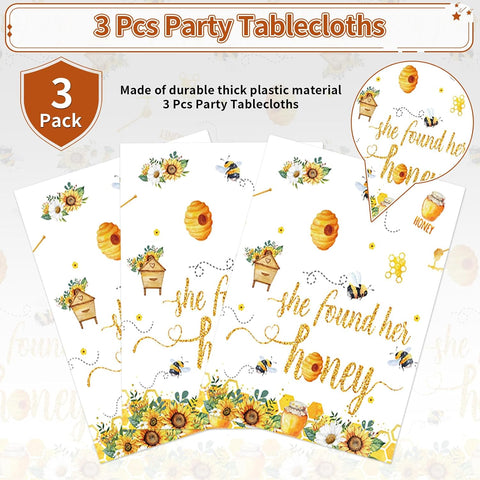 Bridal tablecloth draped on party table with bee themed decorations