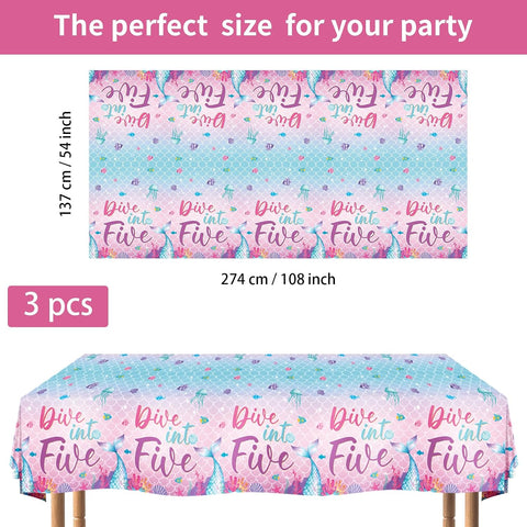 Flat lay of three mermaid birthday tablecloths with ocean waves and seashell design