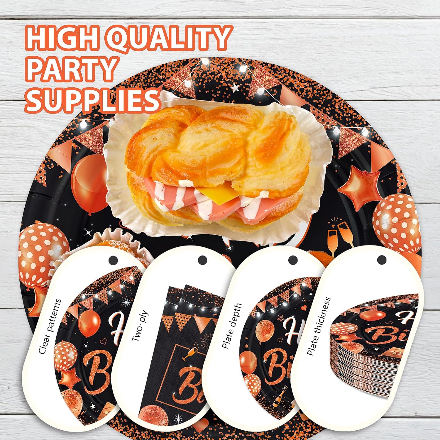 Orange and black birthday dessert plates styled on a party table