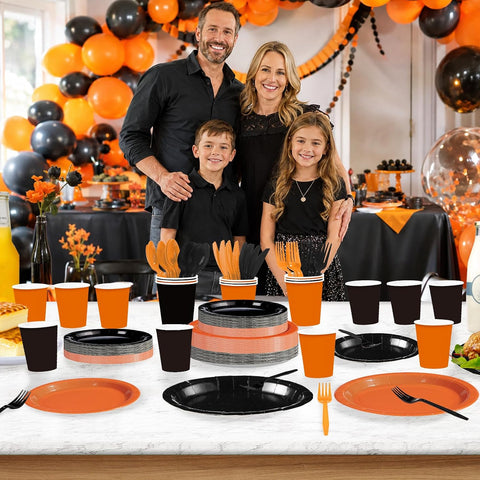 Black and orange cutlery and cups close up