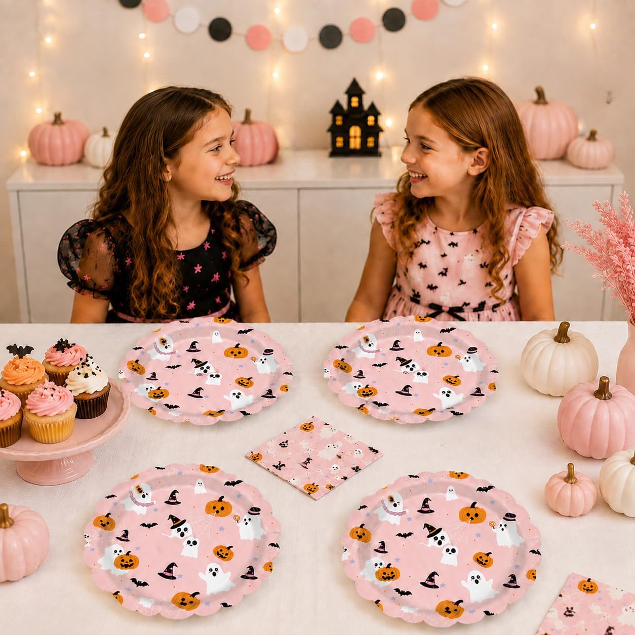 Guests at a pink Halloween party with the ghost plates