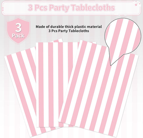Pink striped tablecloth draped on party table with carnival decorations