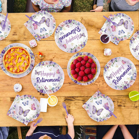 Purple happy retirement paper plates arranged for a farewell party