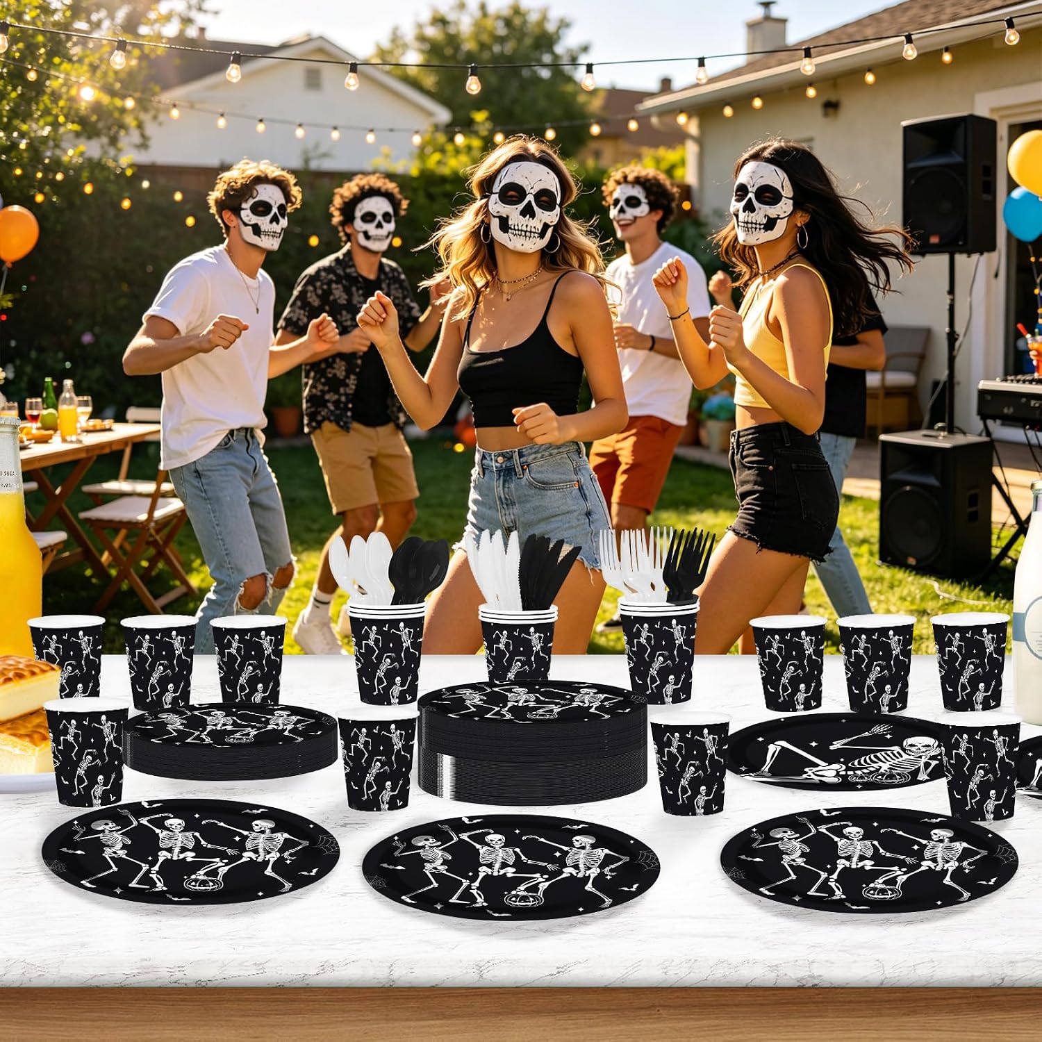 Halloween party guests holding the skeleton paper plates
