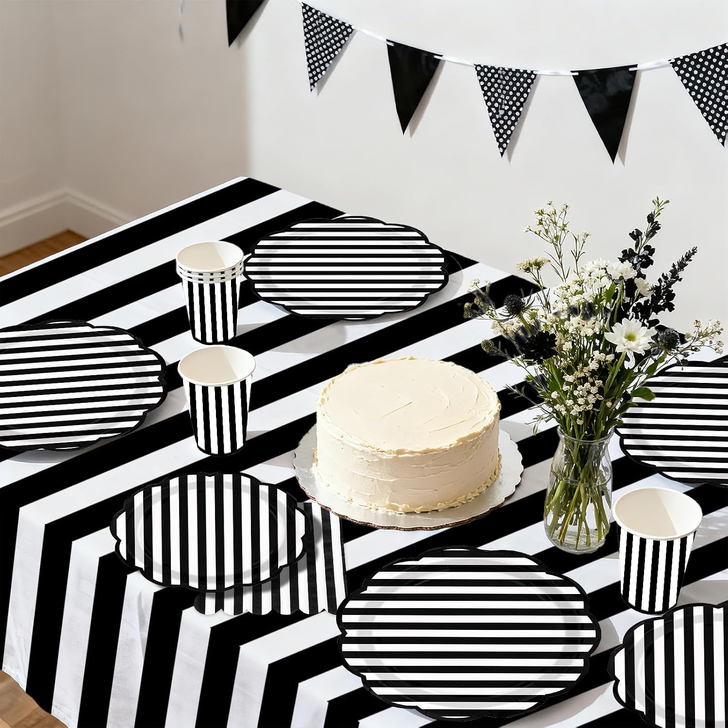 Birthday party table with black white striped tableware