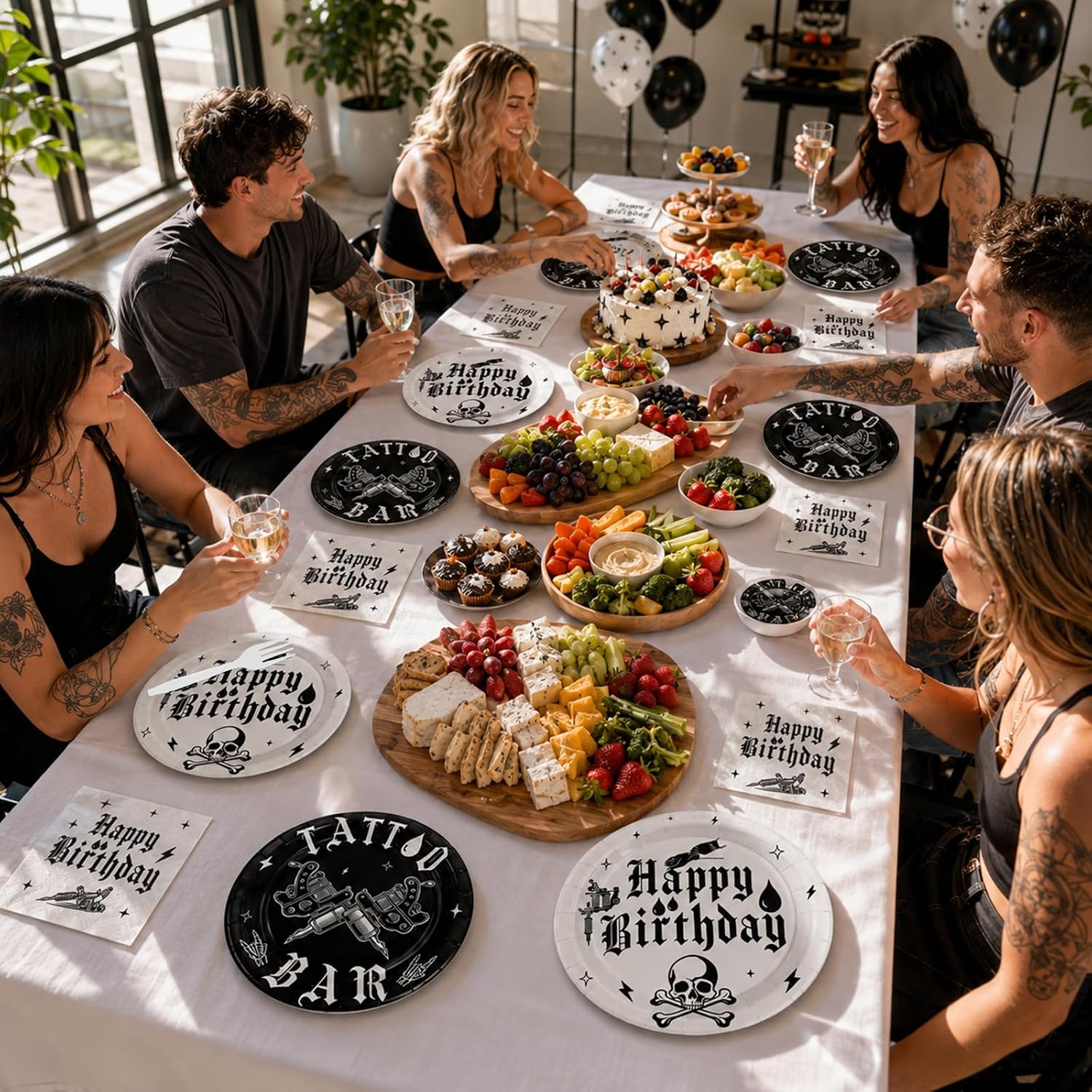 Tattoo themed birthday party table with plates and napkins