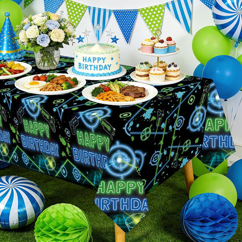 Boys shooting game birthday party scene with laser tag themed tablecloth